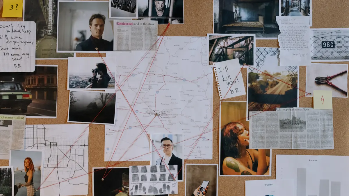 corkboard with map, photos, notes, and string connections